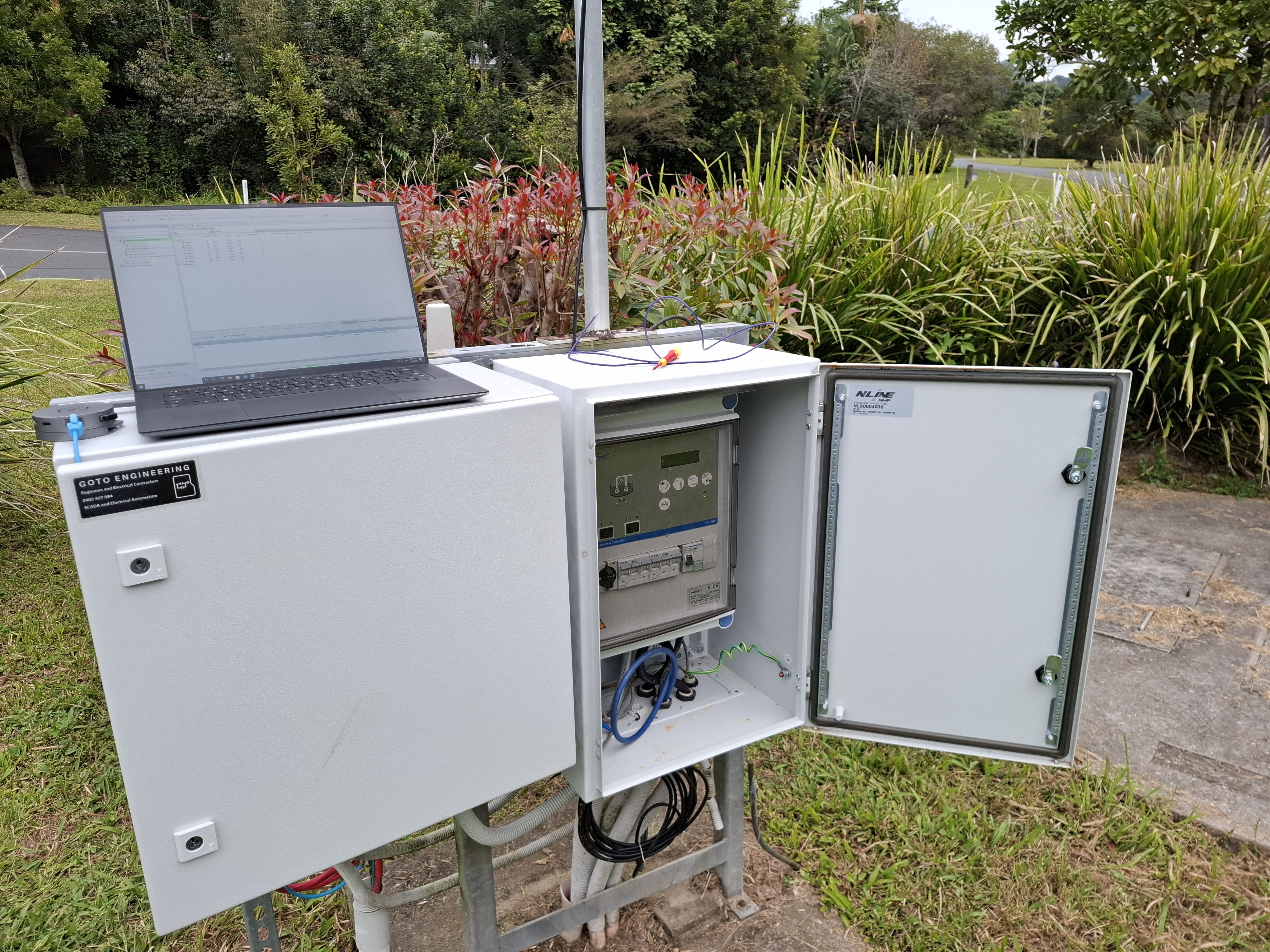 Open Flygt FGC323 General Controller cabinet showing the duty/assist front panel, hand/auto selectors and breaker bank