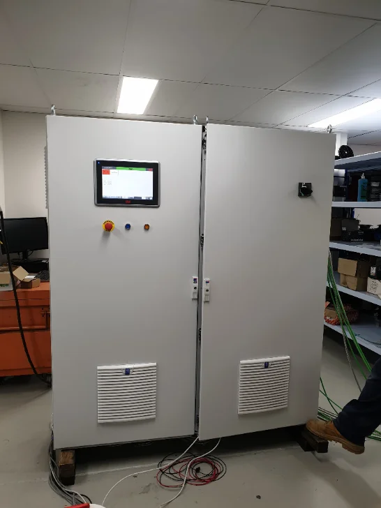 Finished switchboard powered up in the workshop with door HMI live, ready for FAT