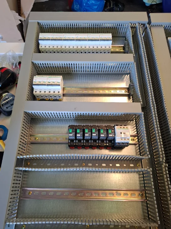 Switchboard fitout in progress — MCBs, sub-distribution and contactor bank on DIN rail