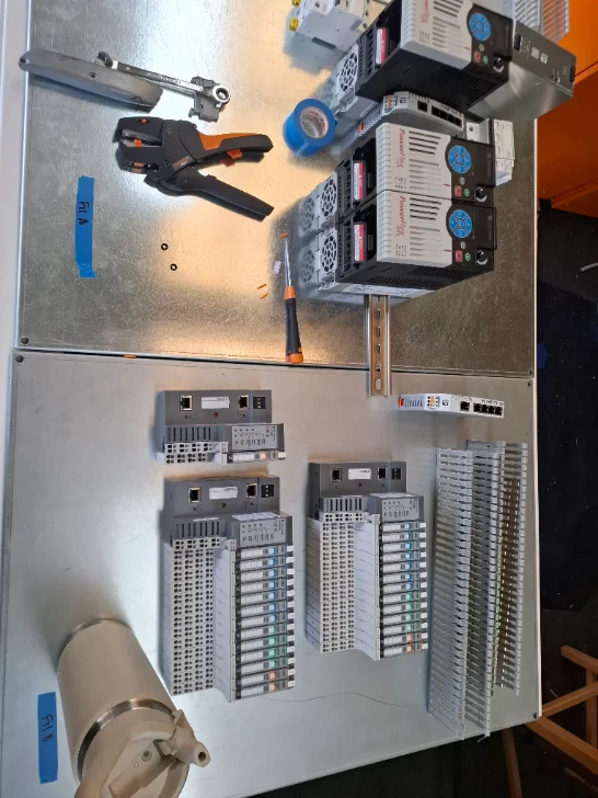 PowerFlex drive bank and Allen-Bradley POINT IO laid out on the workbench during build