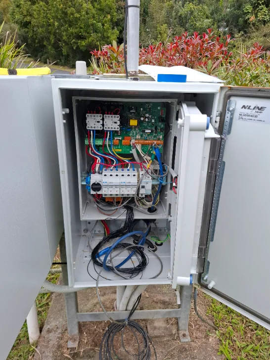 NLINE outdoor pump telemetry enclosure on a stainless stand with cellular antenna above